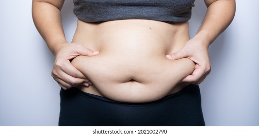 Fat woman hand holding fat belly on white background.
