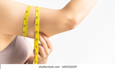 fat woman, woman hand pinching on her excessive fat arm with measure tape, woman diet lifestyle concept