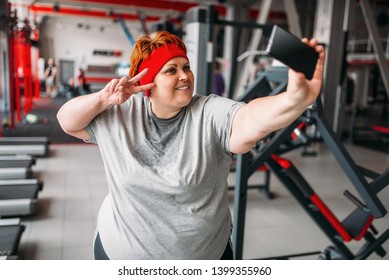 Fat Woman Makes Selfie Against Exercise Machines