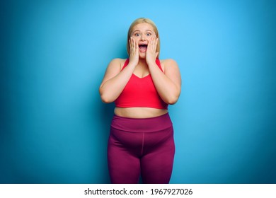 Fat Woman With Shocked And Surprised Expression. Cyan Background