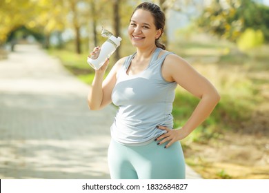 Fat woman and sports. Does exercise for weight loss in the fresh air. High quality photo.