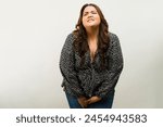 Fat woman with an urge to go to the bathroom while fighting her incontinence problem in a studio