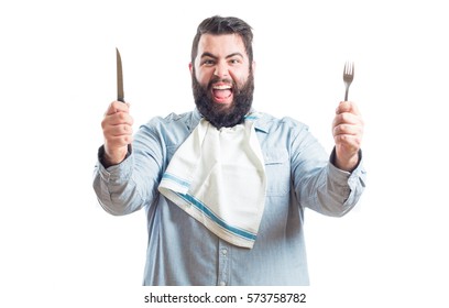 
Fat Young Man With A Napkin In The Neck Of His Shirt Holding A Knife And A Fork Isolated On White Background