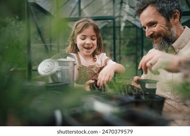 Fater and girl working together in garden, planting seedlings, spending time togeter, have shared hobby. Fatherhood and Father's Day concept. - Powered by Shutterstock