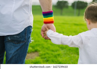 Father and adopted son holding hands. Paternal and sexual equality concept. 
