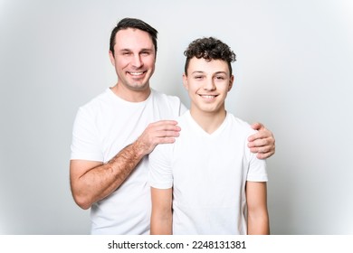 A father with adorable teen son isolated on white - Powered by Shutterstock