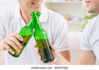 Father And Adult Son Drinking Beer 