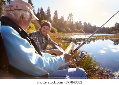 Father And Adult Son Fishing Lakeside, Close-up