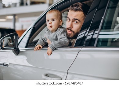 Father With Baby Daughter Sitting In Car