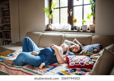 Father with a baby girl at home sleeping.