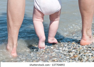 Father And Baby Playing In The Water