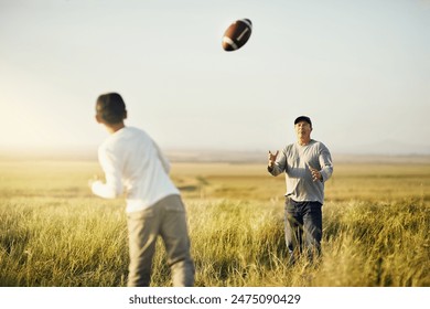 Father, boy child or American football in outdoor for bonding, skills practice with dad in nature. Male person, son and development or training in countryside, together for exercise or learning sport - Powered by Shutterstock