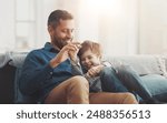 Father, boy and laughing on sofa together in home, bonding and hug for funny conversation. Daddy, son and happy family playing in living room for joke, talk and embrace for security in relationship