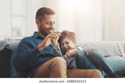 Father, boy and laughing on sofa together in home, bonding and hug for funny conversation. Daddy, son and happy family playing in living room for joke, talk and embrace for security in relationship - Powered by Shutterstock