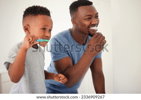Father brushing his teeth with his child for oral hygiene, health and wellness in the bathroom. Dental, teaching and young African man doing his morning mouth routine with his boy kid at their home.