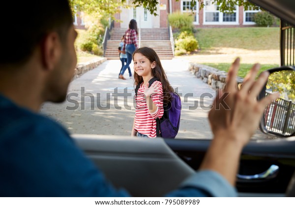 Father In Car Dropping Off Daughter In Front Of\
School Gates