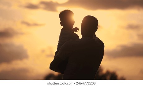 Father care is important kid toddler for healthy family. happy family kid concept. The silhouette of the father holding the son was visible in the sunshine dream. father and son in a forest park - Powered by Shutterstock