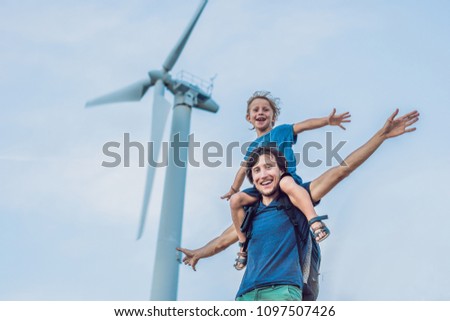 Father carrying son on shoulders and waving their arms like a windmill