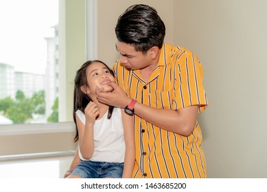 Father Is Checking The Health Of The Doughter's Mouth And Teeth, To Dental Health Concept.