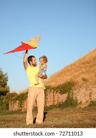 Father With Child Flying A Kite