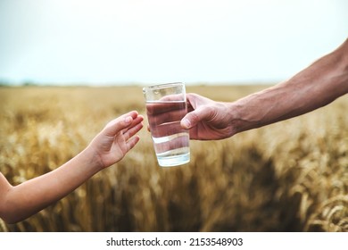 Father And Child With A Glass Of Water. Selective Focus. Kid.