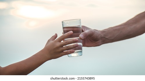 Father and child with a glass of water. Selective focus. Kid. - Powered by Shutterstock