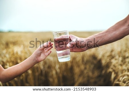 Father and child with a glass of water. Selective focus. Kid.