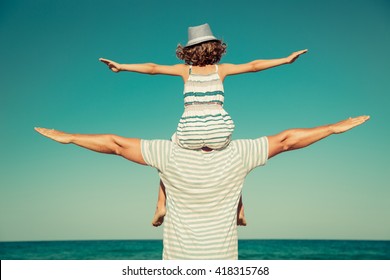 Father And Child Having Fun On The Beach. Summer Vacation And Travel Concept