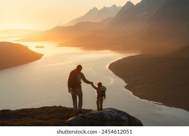 Father and child hiking in Norway traveling together summer vacations adventure trip healthy lifestyle outdoor active dad and daughter kid with backpack enjoying sunset fjord and mountains view  - Powered by Shutterstock