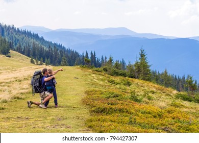 Father And Child Hiking In Scenic Mountains. Dad And Son Enjoying The View From The Mountain Top In Carpathian Mountains