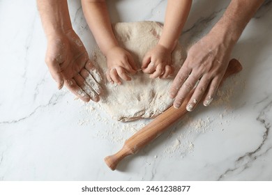 Father and child making dough at white table, top view - Powered by Shutterstock