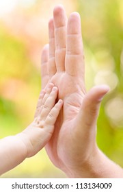 father and child making hi-five gesture