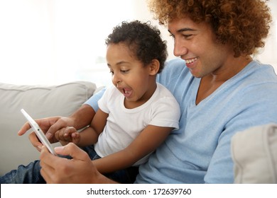 Father And Child Playing With Digital Tablet