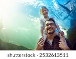 Father, child and portrait for fish in aquarium of education experience, marine learning and coral environment. Family, below and exhibit tank of sea animals, biology development and bonding together