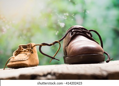 father and child shoes tie the shoestring together in heart shape, love and bound and fathers day concept