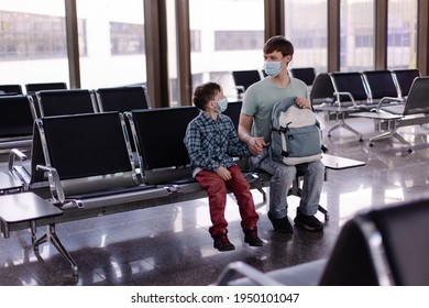 Father And Child Wearing Protective Masks In A Public Place. Family Dad Son At Airport Awaits Departure For The Covid-19 Pandemic. Bus Train Station Rules For Travel To Lockdown. New Normal Lifestyle