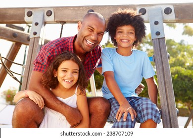 Father With Children On Playground Climbing Frame - Powered by Shutterstock