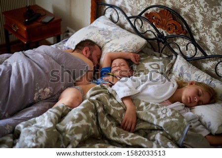 Similar – Image, Stock Photo Man reading with wife and son sleeping