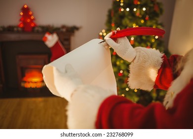 Father Christmas Writing With A Quill At Home In The Living Room