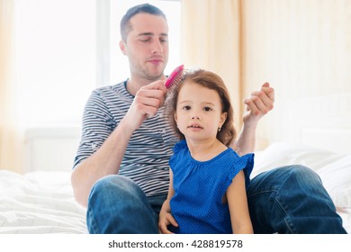 Father combing hair of his daughter in the morning - Powered by Shutterstock