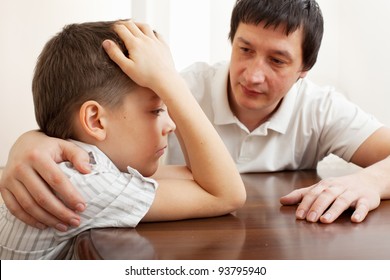 Father Comforts A Sad Child. Problems In The Family