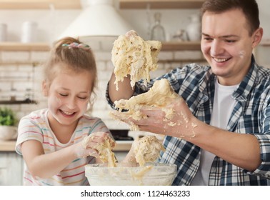 Father Is Cooking Pastry With Daughter First Time In Kitchen. Happy Man And Little Girl Kneading Too Liquid Dough And Laughing, Fail With Recipe, Copy Space