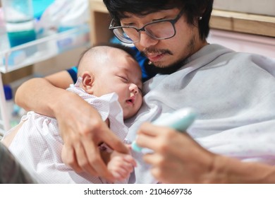 Father Cutting My Baby's Nails With Electic Nail Clipper While Baby Sleep.