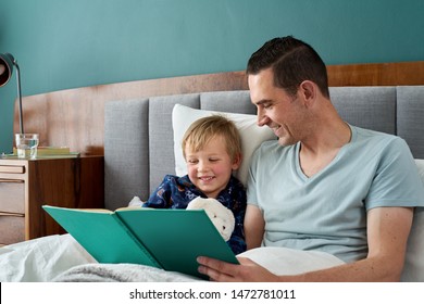 Father Dad In Bed With Son Reading Stories Story Telling At Bedtime, Closeness Relationship Love Bonding