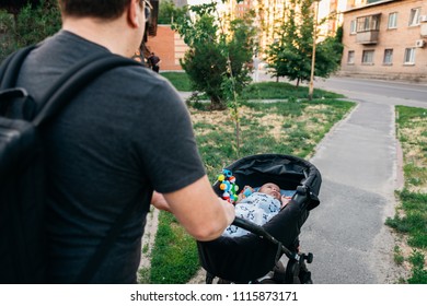 Father Dad With Newborn Pram Stroller Outside During Summer Evening Sunset In The City Streets