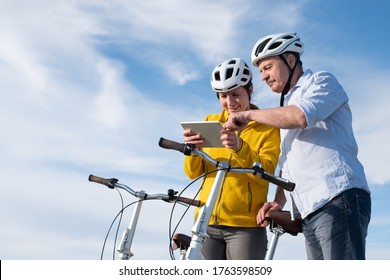 Father and daughter cycling outdoors looking for right route being lost. - Powered by Shutterstock