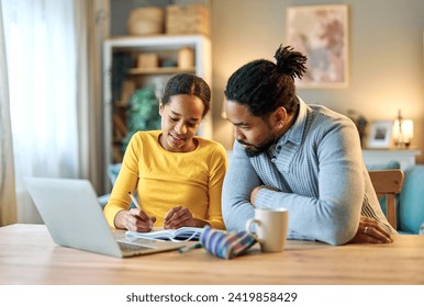 Father and daughter doing homework with laptop at home. Father and teenage girl happy using laptop. Teen girl and dad sitting at home working with notebook - Powered by Shutterstock