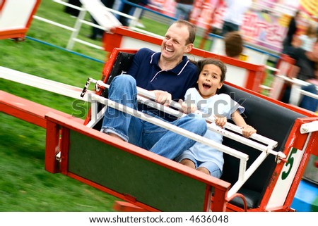 Father and daughter enjoying the fast octopus ride at the amusement fair in the park. Stock photo © 
