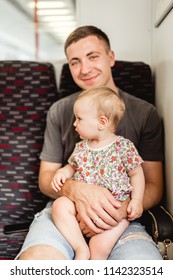 Father and daughter enjoying trip on train.