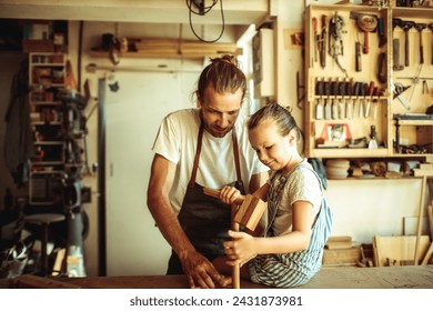 Father and daughter enjoying woodworking in a home workshop - Powered by Shutterstock